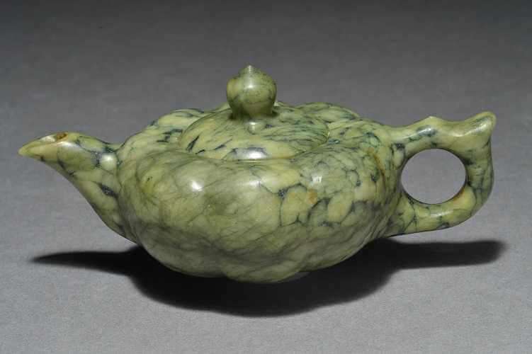 Green lobed teapot made of jade.